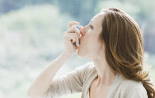 Woman with inhaler for asthma