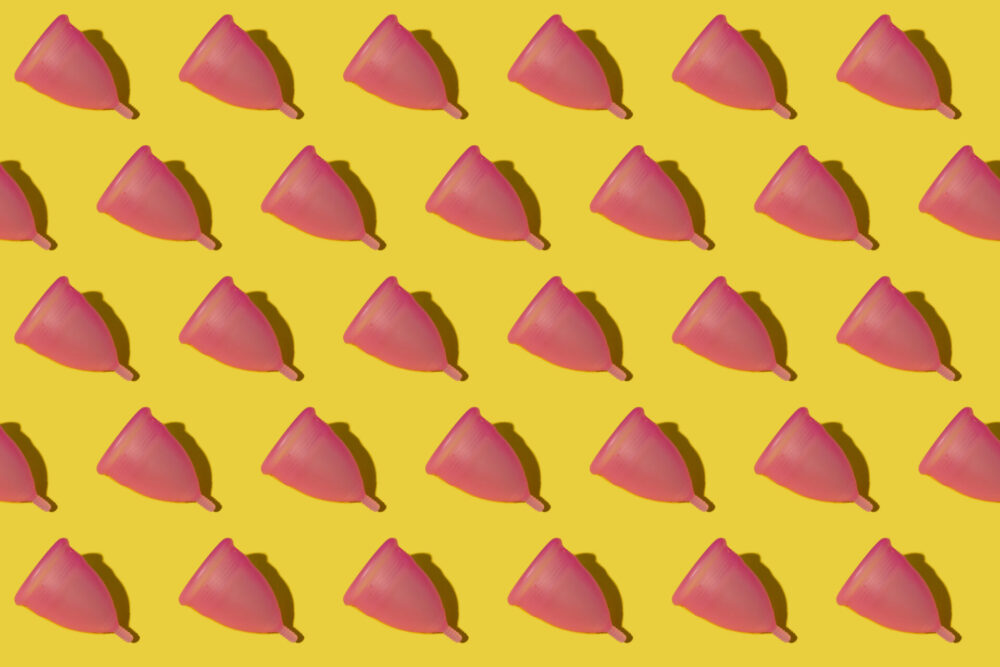 Pattern of rows of pink menstrual cups