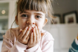 Small child putting something in her mouth