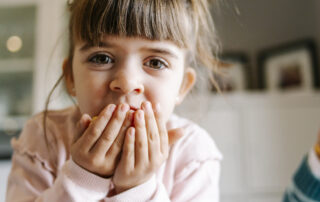Small child putting something in her mouth