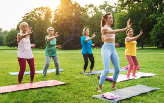 Senior women training with fitness coach at park