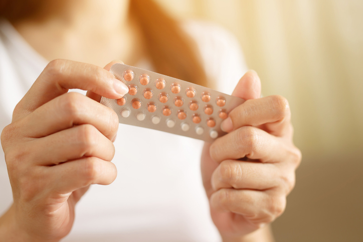Woman's hands holding a packet of contraceptive pills