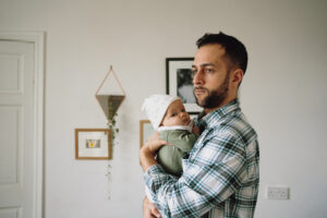 A new dad holding his baby