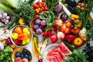 Fresh homegrown vegetables and fruits on kitchen table summer harvest from a table top view