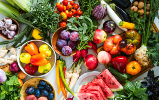 Fresh homegrown vegetables and fruits on kitchen table summer harvest from a table top view