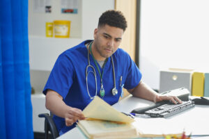 Doctor sitting at a desk with paperwork