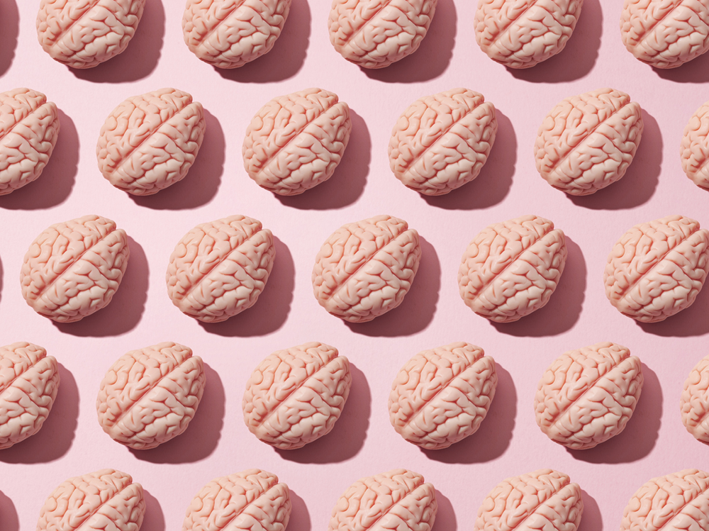 A collage of human brain graphics on a pink background