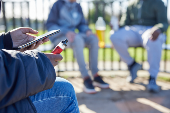 Teens vaping in a park